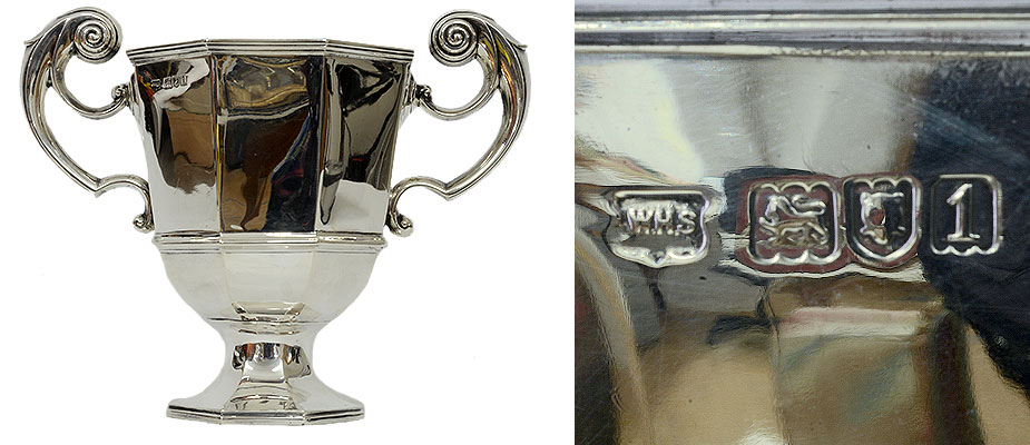 Henkelpokal_19Jh Henkelpokal, England Achteckiger silberner Pokal, die Henkel geschwungen und mit gedrehten Schneckenabschlüssen. Auf dem Pokalrand, Mastermark WHS Wilhelm Henry Sparrow, Schreitender Löwe nach Links 925 Silber, Stadtmarke London, Jahresmarke 1906. Maße: Gewicht: 455 gr. London 1906